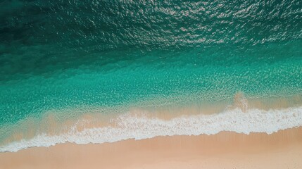 Obraz premium Aerial view of tranquil turquoise sea meeting a sandy beach with gentle waves and clear space for your text or design elements