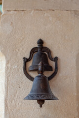 Obraz premium Old bronze bell on the wall of a church in Provence, France