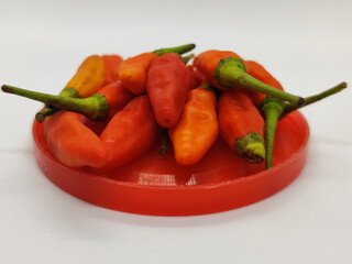 Small chili. Cayenne pepper on a red container.