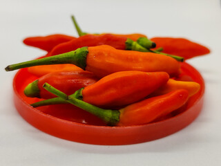 Small chili. Cayenne pepper on a red container.