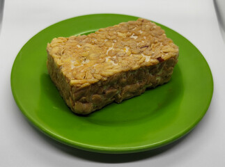 Soybean tempeh. Tempeh is a typical Indonesian food made from fermented soybeans mixed with yeast.