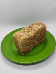 Soybean tempeh. Tempeh is a typical Indonesian food made from fermented soybeans mixed with yeast.