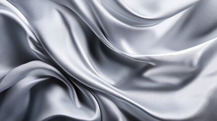 Fototapeta premium Elegant silver satin fabric texture with graceful folds and soft sheen for luxurious design backgrounds and presentations.