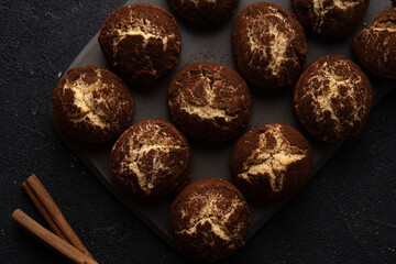 Cinnamon crinkle cookies on a black background flat lay, recipe concept. close-up