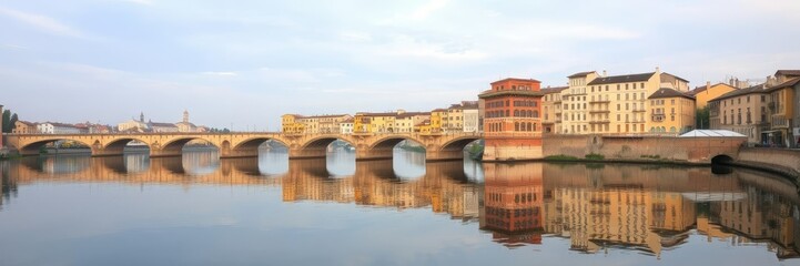 Fototapeta premium Calm waters of the Arno River reflecting the Ponte Vecchio, florence italian landscape, arne river, calm water