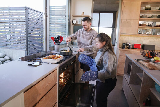Disabled man and woman preparing dinner in kitchen
