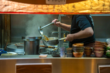 View of chefs busy at work through restaurant window in Omicho Market, Kanazawa City, Ishikawa Prefecture, Honshu, Japan