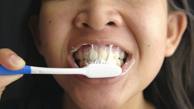 Close up of woman brushing her teeth. daily routine