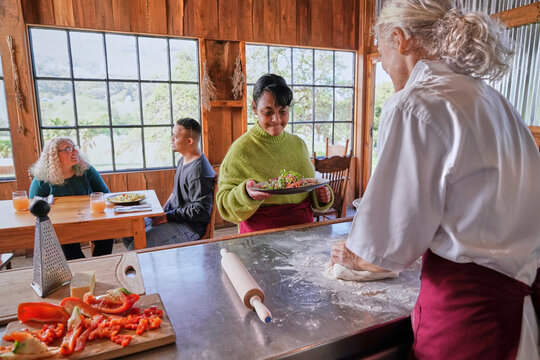 Waitress taking ordered dish from counter