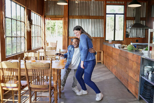 Two employees standing and embracing in restaurant
