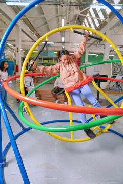 Teenager on gyroscope in science center