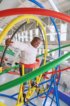 Teenager with cerebral palsy on gyroscope in science center