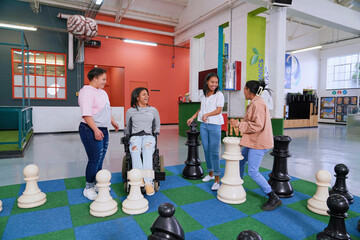 Children playing large scale chess at science center
