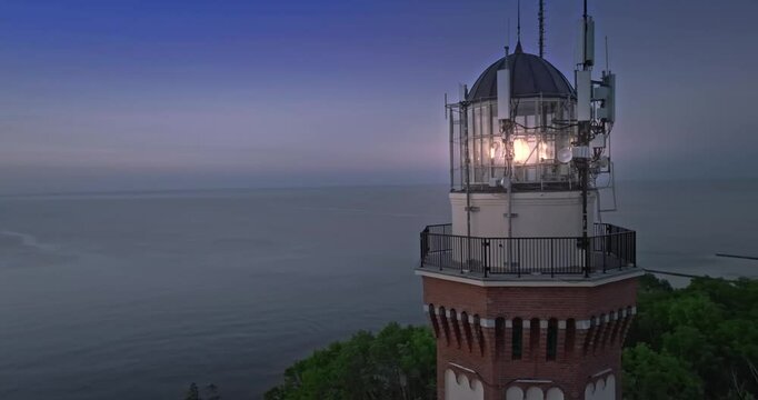 Light beam and lighthouse at Baltic Sea during sunset.