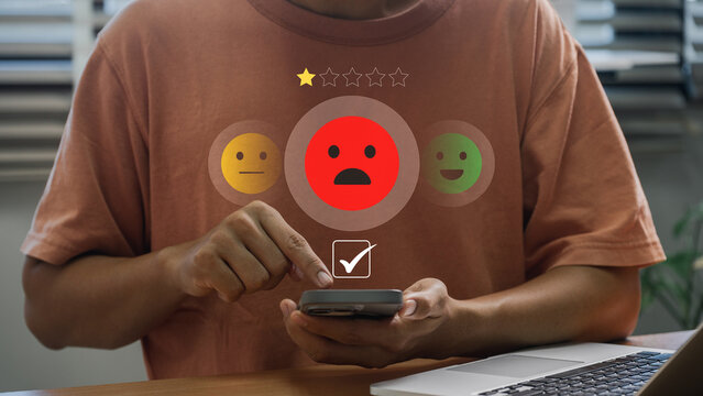 User Providing Poor Feedback on Mobile Device. One Star Rating with Red Unhappy Icon Depicting Negative Customer Experience, Service Criticism, and Consumer Frustration