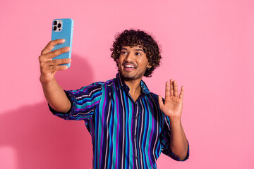 Photo of nice young man smart phone selfie arm wave hi wear shirt isolated on pink color background © deagreez