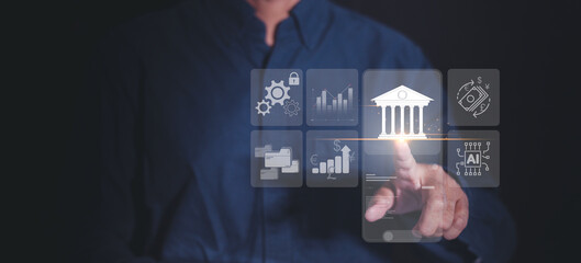 A professional businessman interacting with digital icons, including graphs and a bank symbol, representing financial technology and data management. showcasing the fintech concept