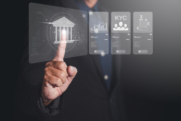 A businessman interacts with a futuristic touchscreen display featuring bank-related graphics and data analytics. symbol of modern technology business. data analytics, check financial online data.