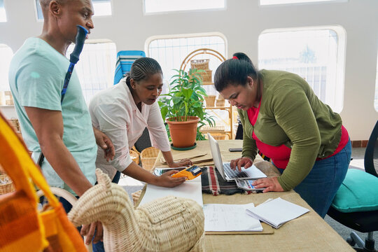 Customers paying for shopping in crafts shop