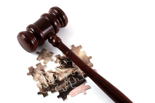 A fragment of a 100 US dollar bill assembled from puzzles and a  on a white background
