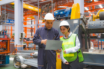 Female Japanese expertise engineering manager or Mechanic are working, planning or discussing with engineer about metal sheet and machine quality in factory, Inspector checking safety of manufacturing