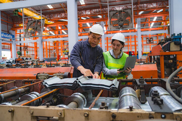 Fototapeta premium Female Japanese expertise engineering manager or Mechanic are working, planning or discussing with engineer about metal sheet and machine quality in factory, Inspector checking safety of manufacturing