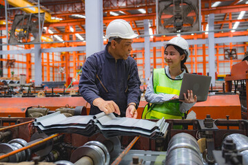 Female Japanese expertise engineering manager or Mechanic are working, planning or discussing with engineer about metal sheet and machine quality in factory, Inspector checking safety of manufacturing