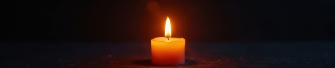 Soft warm glow of a single candle flame illuminated against a dark background , candle, light, warm