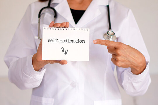 self-medication concept. woman doctor noting the importance of the problem with words written in her notebook