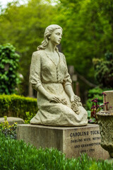 Statue Memorial with Roses at Highgate Cemetery in London