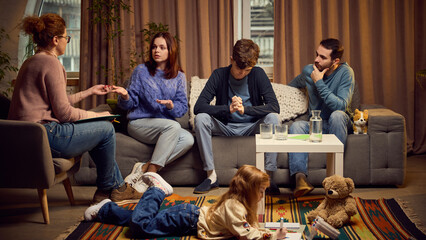 Conflict resolution, communication with teens. Parents with their teen boy visiting psychologist, aiming to maintain communication with their child. Concept of psychology, assistance, therapy