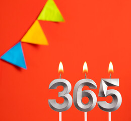 Number 365 in the form of candles on a red background