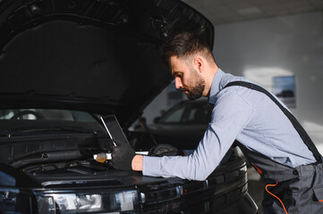 Troubleshooting process. Auto mechanic working in garage. Repair service