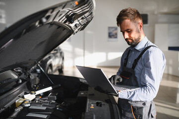 Mechanic Uses a Computer with an Augmented Reality Diagnostics Software. Specialist Inspecting Car's Engine to Quickly Spot Broken Components. Premium Car Service