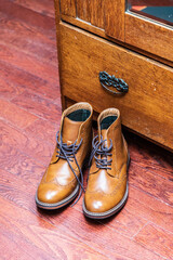 Brown Leather Dress Shoes Placed on Wooden Floor Near Furniture