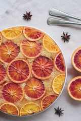 Delisious freshly baked homemade blood orange upside-down cake, top view on neutral background....