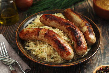 A bowl with Bratwurst and Sauerkraut as side dish - traditional German food	