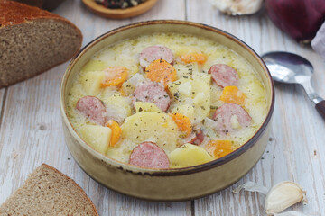 A bowl with traditional German potato soup with sausages