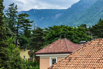 Charming Roofs and Surrounding Forested Mountains in Merano, Italy