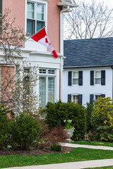 Charming Residential Home with Canadian Flag in Springtime Garden