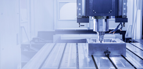 Modern CNC milling machine during operation, blue toning. Produced cutting metal parts, industry heavy factory