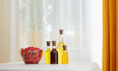 Extra virgin set oil of sunflower, olive in glass bottles for dressing vinaigrette salad on background of kitchen, eco nature super food