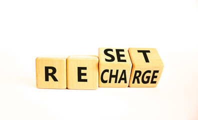 Reset and recharge symbol. Concept words Reset Recharge on beautiful wooden block. Beautiful white...