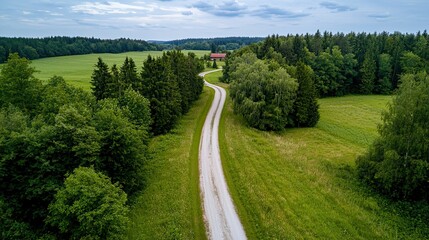 Fototapeta premium Winding path through green fields nature aerial