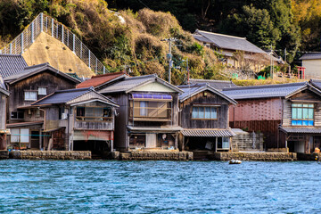 Obraz premium Row of Traditional Japanese Boat Houses Along Waterfront, Ine, Kyoto, Japan