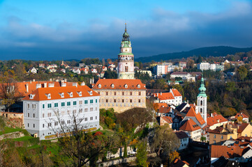 Fototapeta premium Panoramic view of Cesky Krumlov, showcasing the UNESCO-listed historic center surrounded by the Vltava River in a meander. A sunny autumn day highlights the town's charm.