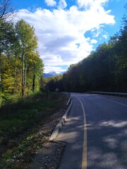 paved highway in a mountainous area in early autumn with panoramic views