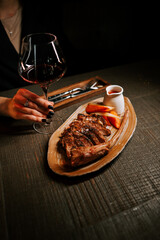 Succulent meat with savory sauce and a glass of rich red wine on an elegant dining table