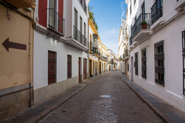 Empty street between houses in Cordoba, Spain.