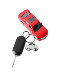 Car key with keychain and toy isolated on white, top view. Buying auto